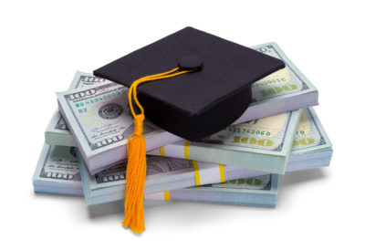 Pile of Money with Graduation Hat Isolated on White Background.